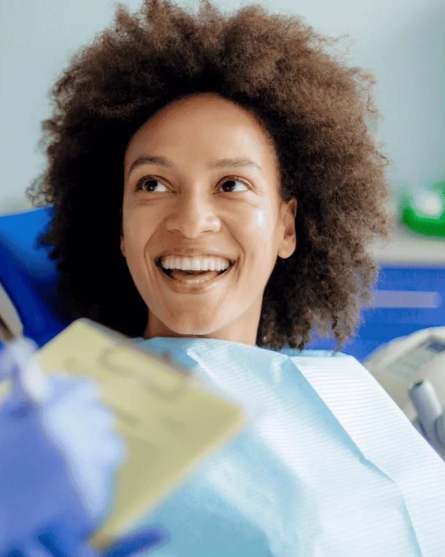A woman smiling during a dental consultation